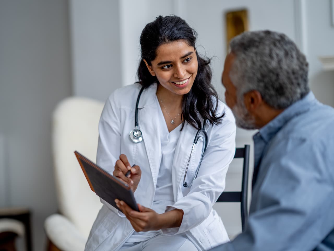 Doctor reviewing results on a tablet with an older patient